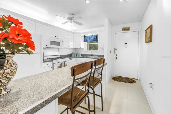 a kitchen with stainless steel appliances granite countertop a refrigerator sink and cabinets