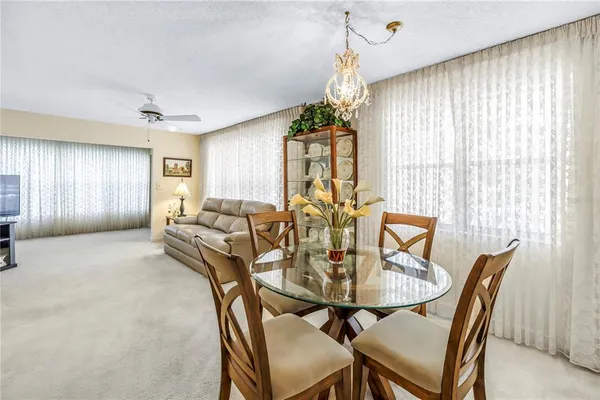 a view of a a dining room with furniture window and outside view