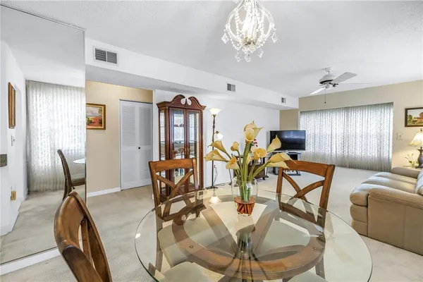 a view of a dining room with furniture and chandelier