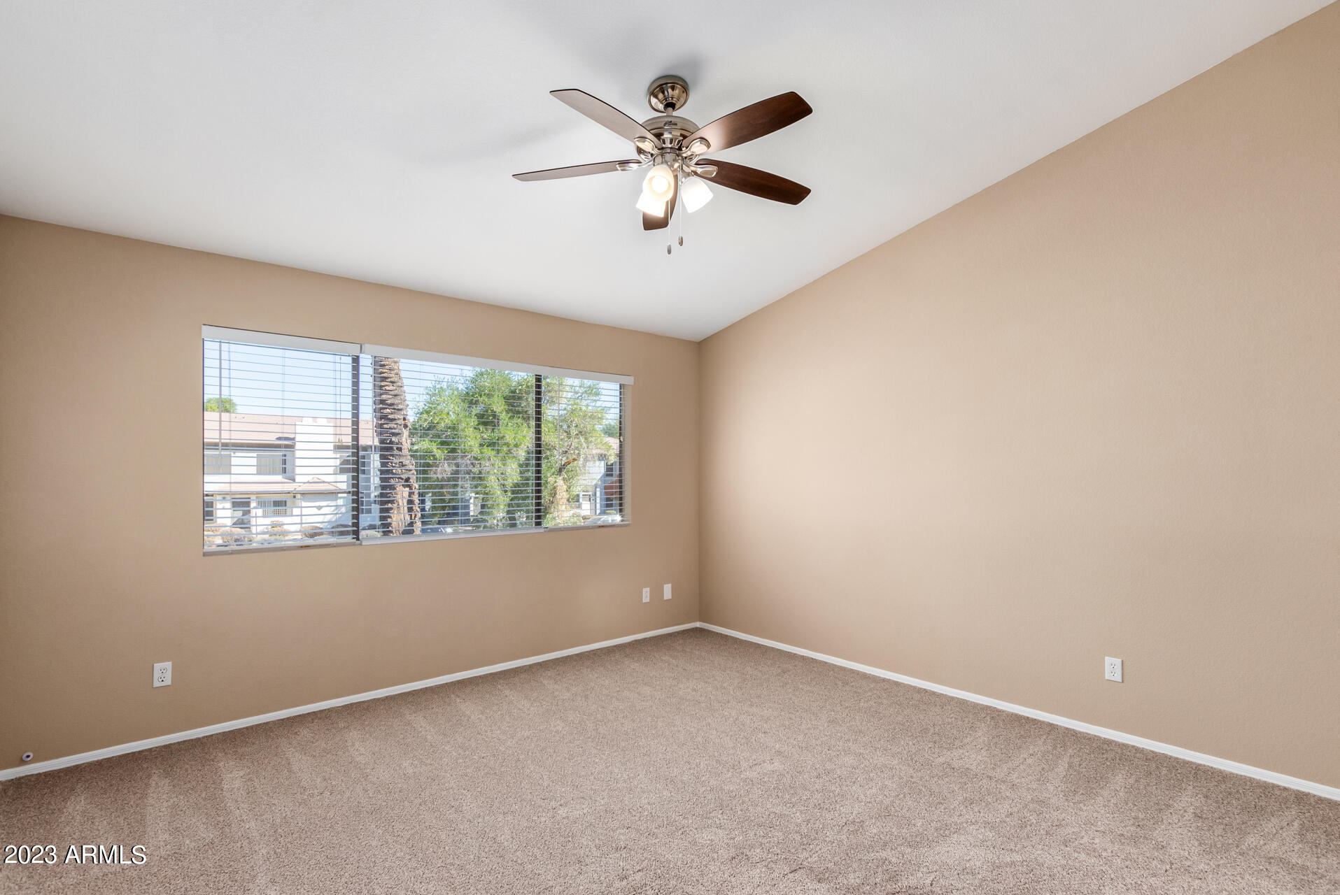 4266 East Agave Road Phoenix, AZ 85044 - Photo 17 of 54 an empty room with windows and ceiling fan