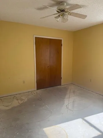 an empty room with a ceiling fan