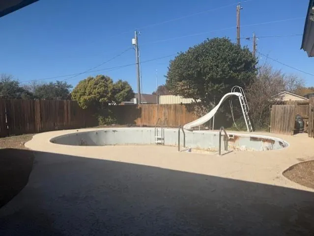 a view of a swimming pool with a yard