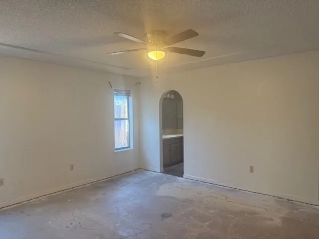 an empty room with windows and entrance