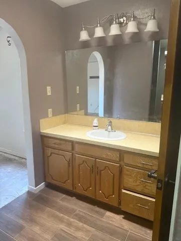 a bathroom with a sink mirror and vanity