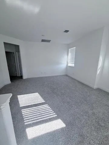 a view of a livingroom with wooden floor and a cabinet