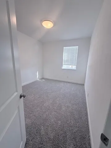 a view of room with window and hardwood floor