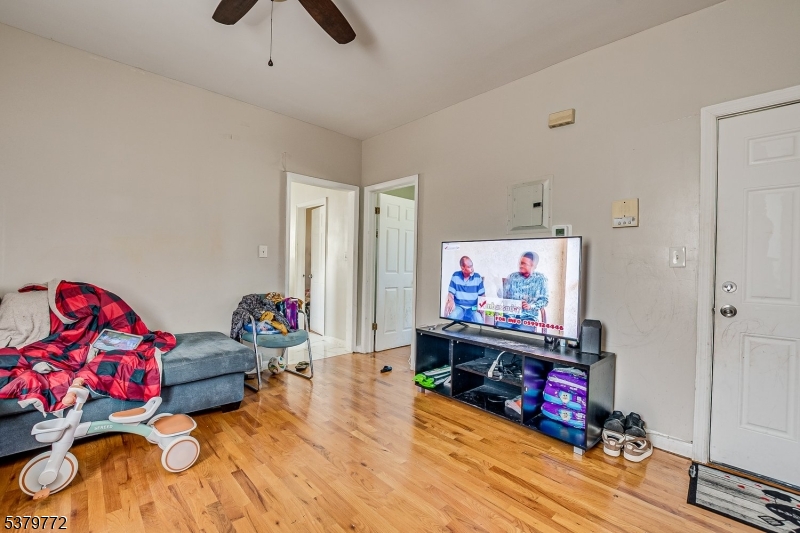 369 21st Street Irvington, NJ 07111 - Photo 11 of 16 a living room with furniture and a flat screen tv