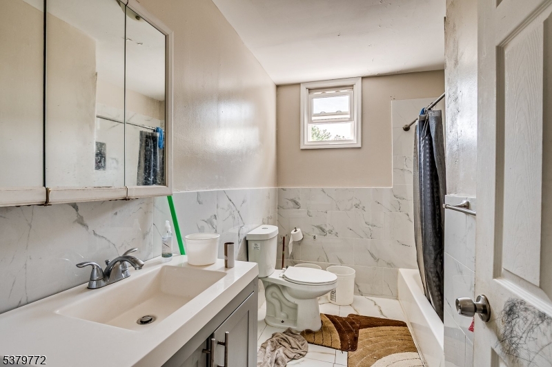 369 21st Street Irvington, NJ 07111 - Photo 13 of 16 a bathroom with a sink toilet and shower