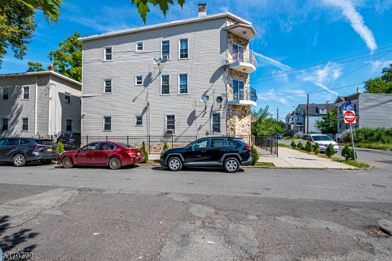 369 21st Street Irvington, NJ 07111 - Photo 2 of 16 a view of a cars parked in front of a house