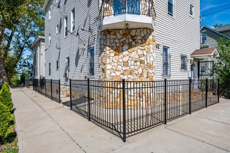 369 21st Street Irvington, NJ 07111 - Photo 5 of 16 a view of a wrought iron fences in front of house