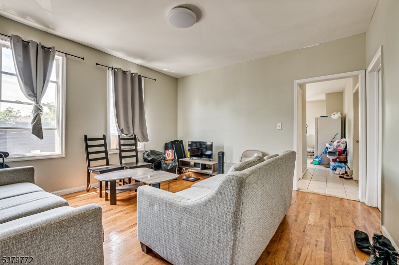 369 21st Street Irvington, NJ 07111 - Photo 6 of 16 a living room with furniture and a large window