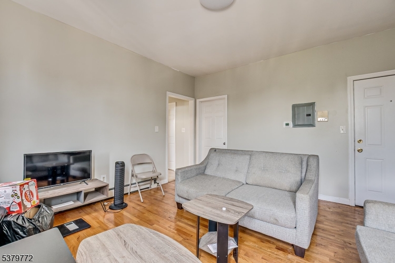 369 21st Street Irvington, NJ 07111 - Photo 7 of 16 a living room with furniture and a flat screen tv
