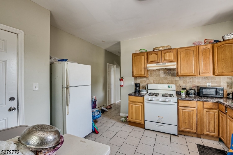 369 21st Street Irvington, NJ 07111 - Photo 9 of 16 a kitchen with a sink a stove and cabinets
