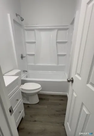 a bathroom with a toilet a sink and bathtub
