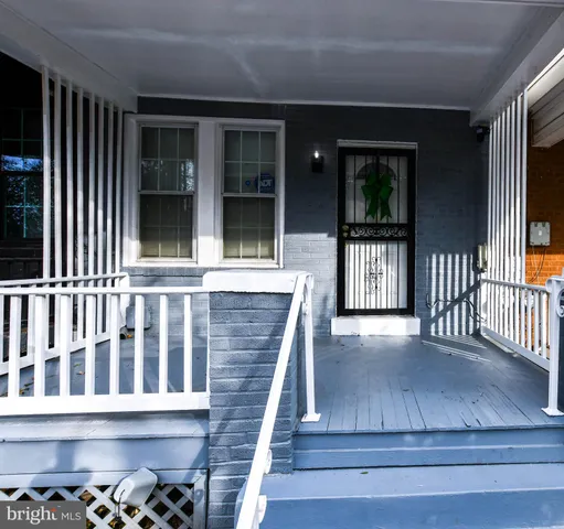 a view of a porch with wooden floor and a floor to ceiling window
