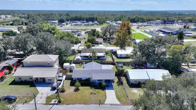 an aerial view of residential house with outdoor space and parking