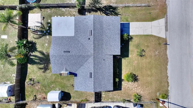 an empty room with a window and a ceiling fan