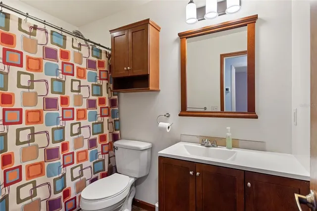 a view of a livingroom with a ceiling fan and wooden floor