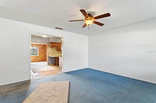 a view of a big room with wooden floor and windows
