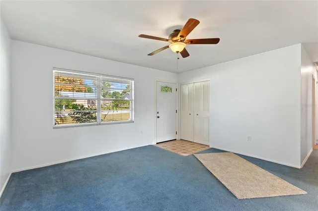 a view of an empty room with a fireplace and a window