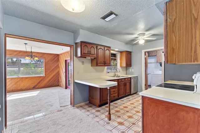 a kitchen with stainless steel appliances a sink stove and refrigerator
