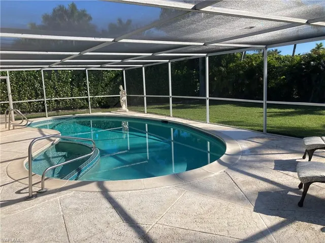 a view of a backyard with swimming pool