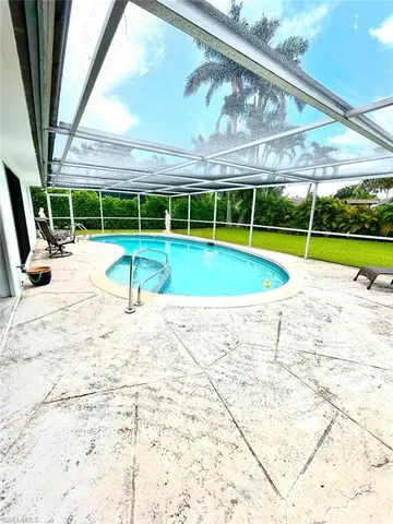 a view of a swimming pool with a yard