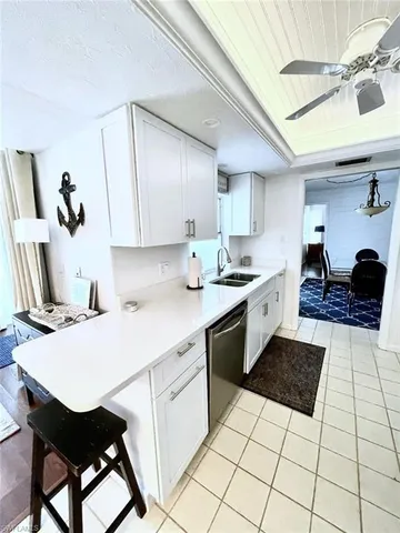 a kitchen with a sink a stove cabinets and black appliances