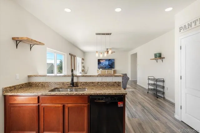 a view of kitchen island a granite countertop living room