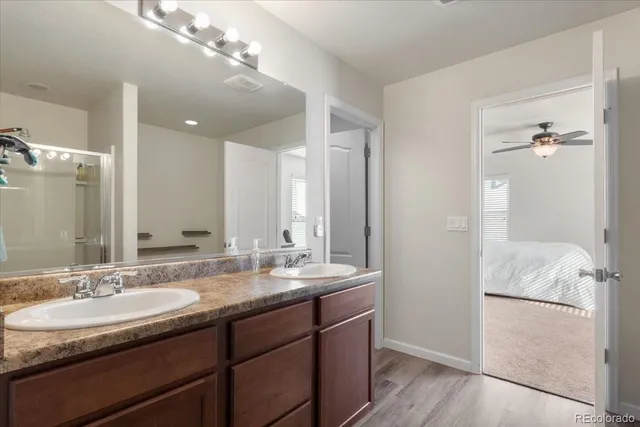 a bathroom with a sink double vanity and a mirror