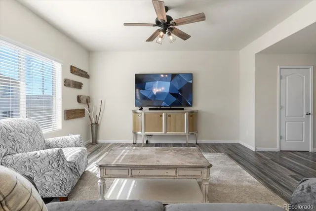 a living room with a couch a rug and a flat screen tv