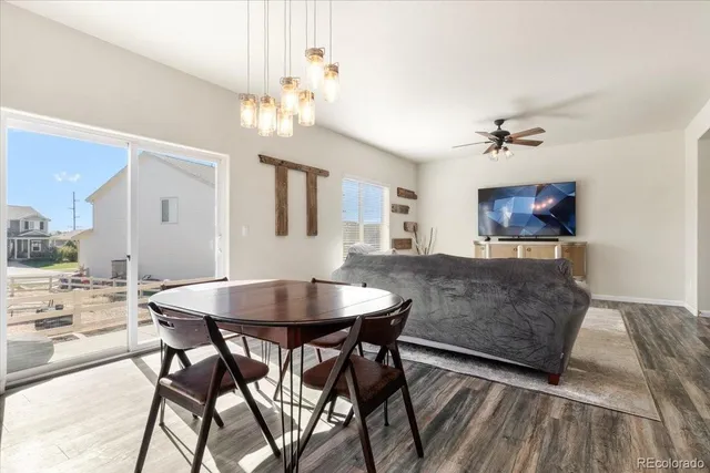 a view of a dining room with furniture and chandelier