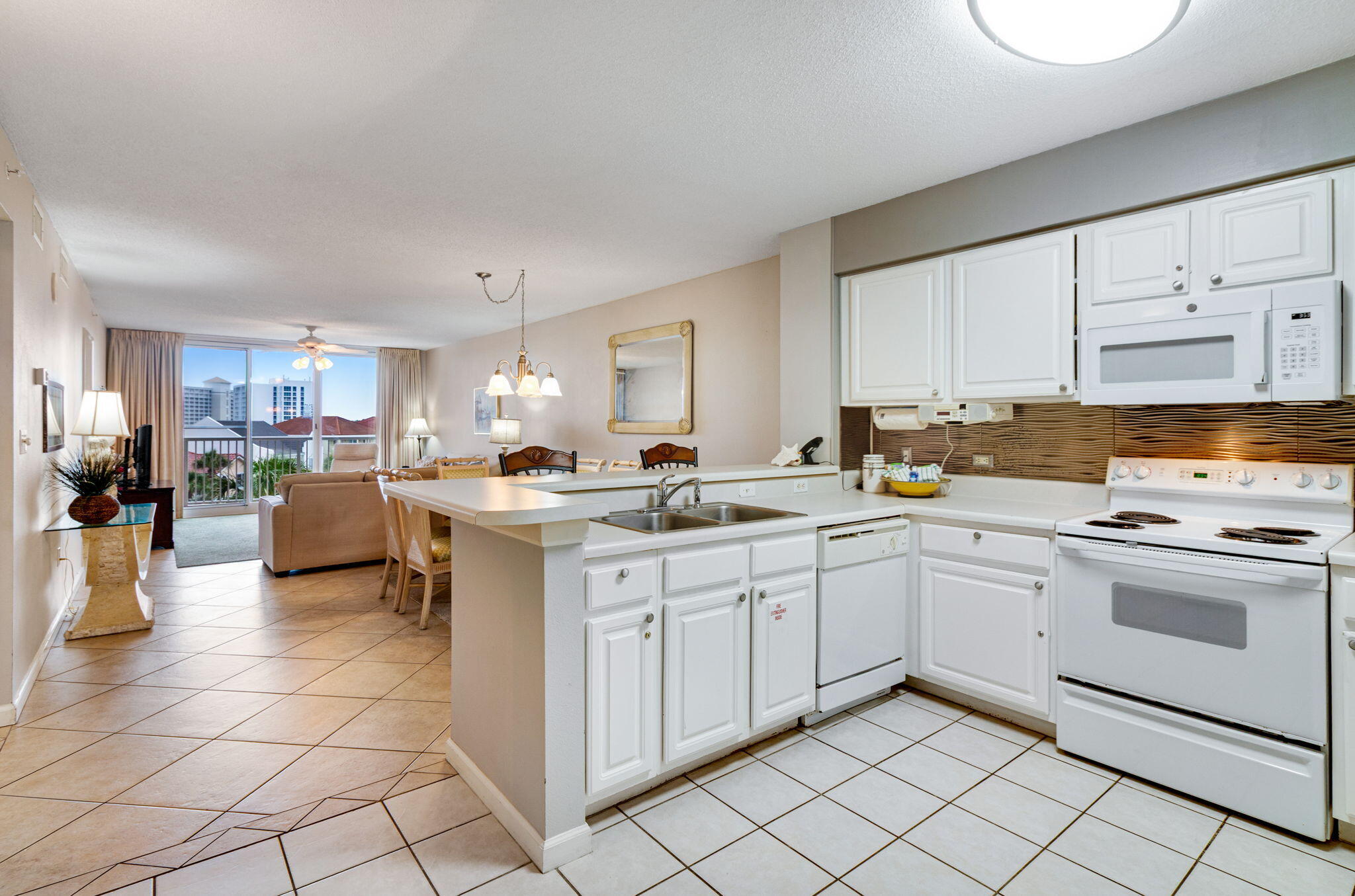 970 Highway 98, Unit 303 Destin, FL 32541 - Photo 17 of 42 a kitchen with cabinets and sink