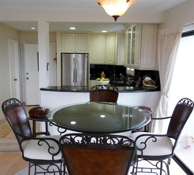 3375 Foothill Road, Unit 631 Carpinteria, CA 93013 - Photo 2 of 7 a kitchen with a dining table chairs and a refrigerator