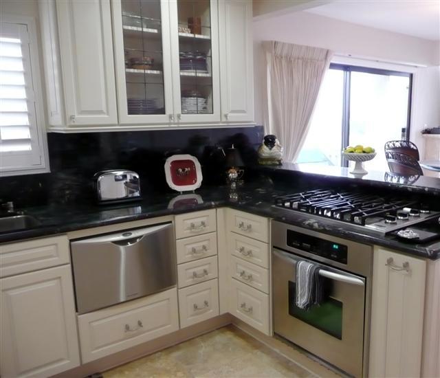 3375 Foothill Road, Unit 631 Carpinteria, CA 93013 - Photo 5 of 7 a kitchen with stainless steel appliances granite countertop white cabinets and a stove a window