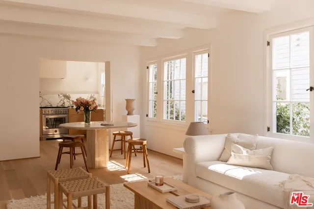 a living room with furniture and large windows