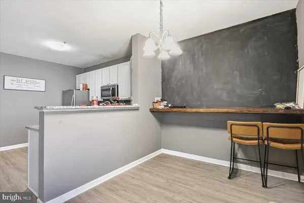 a kitchen with kitchen island a sink cabinets and wooden floor