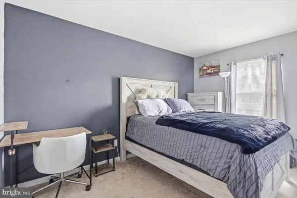 a bedroom with a bed and a chair