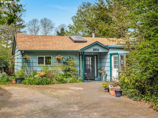 a front view of a house with a garden