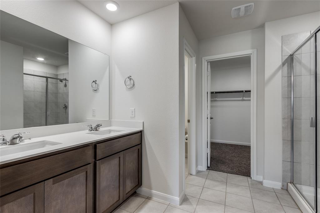 504 Stampede Lane Princeton, TX 75407 - Photo 9 of 13 a bathroom with a double vanity sink a and mirror