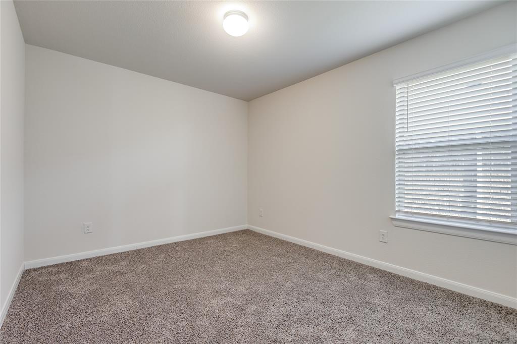 504 Stampede Lane Princeton, TX 75407 - Photo 4 of 13 an empty room with a window