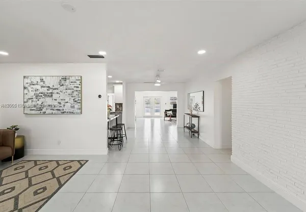 a living room with furniture and a dining table with kitchen view