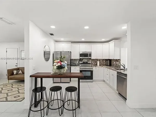 a kitchen with stainless steel appliances a stove sink and cabinets