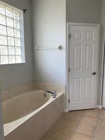 a bathroom with a bathtub and shower