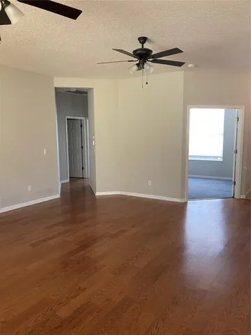 a view of a room with wooden floor closet and windows