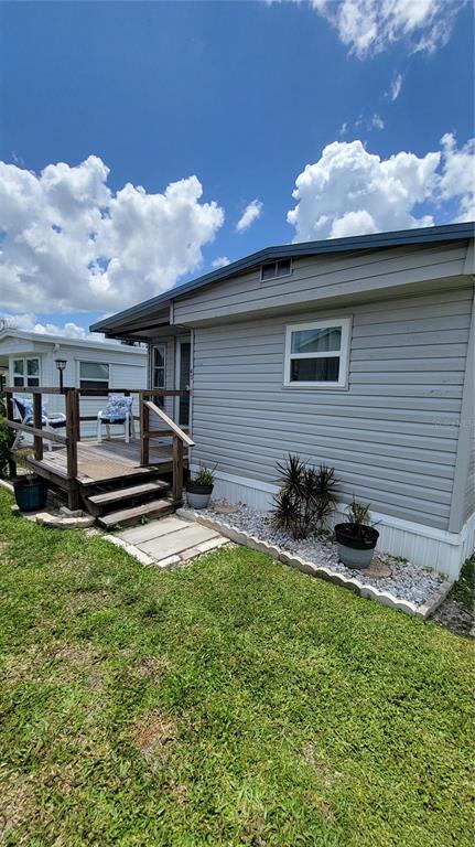 a backyard of a house with barbeque oven and outdoor seating