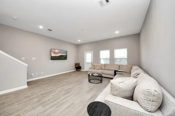a view of a kitchen center island wooden floor and windows
