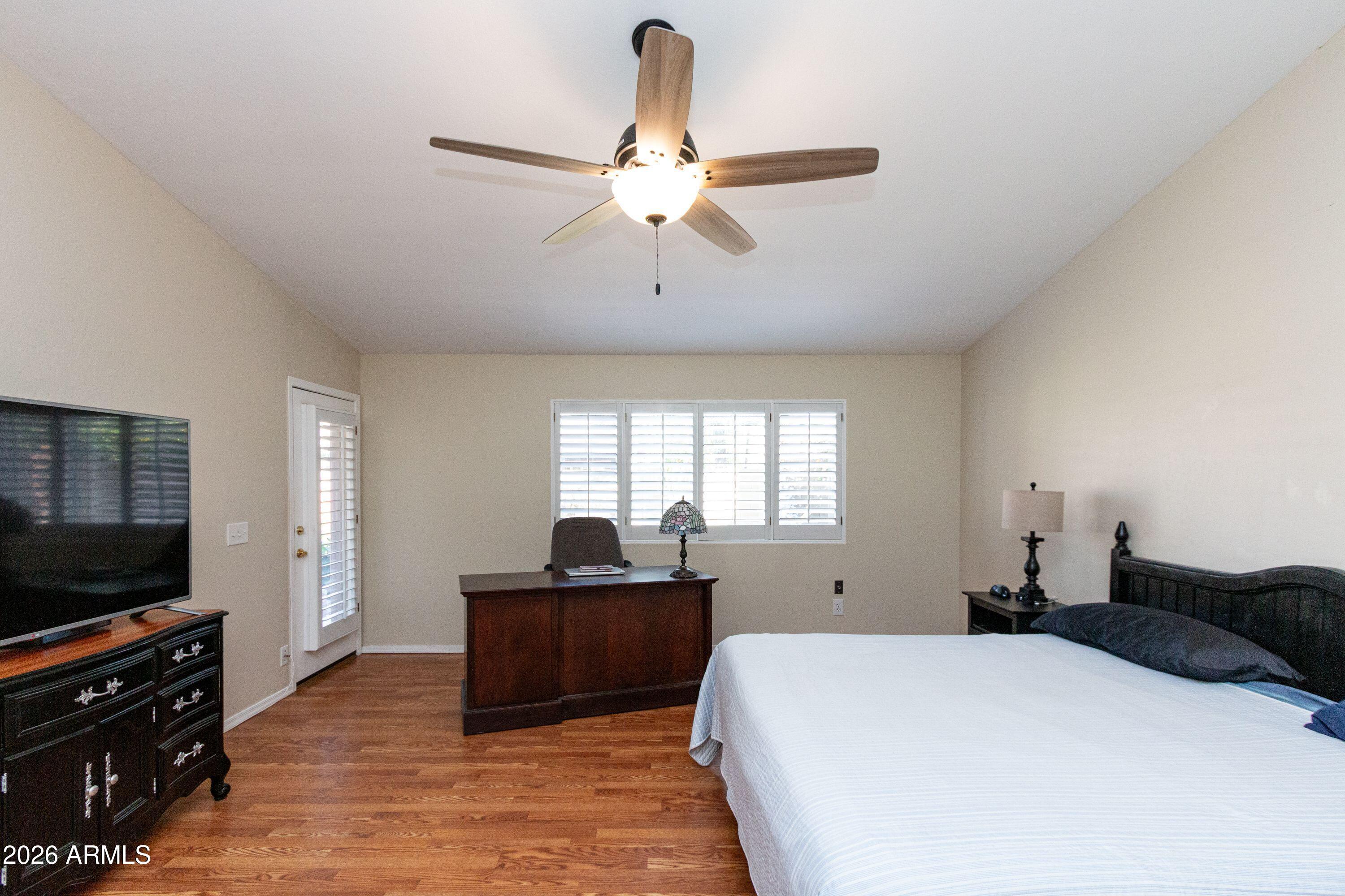 450 East Merrill Avenue Gilbert, AZ 85234 - Photo 13 of 26 a bed room with a bed a flat screen tv and a window