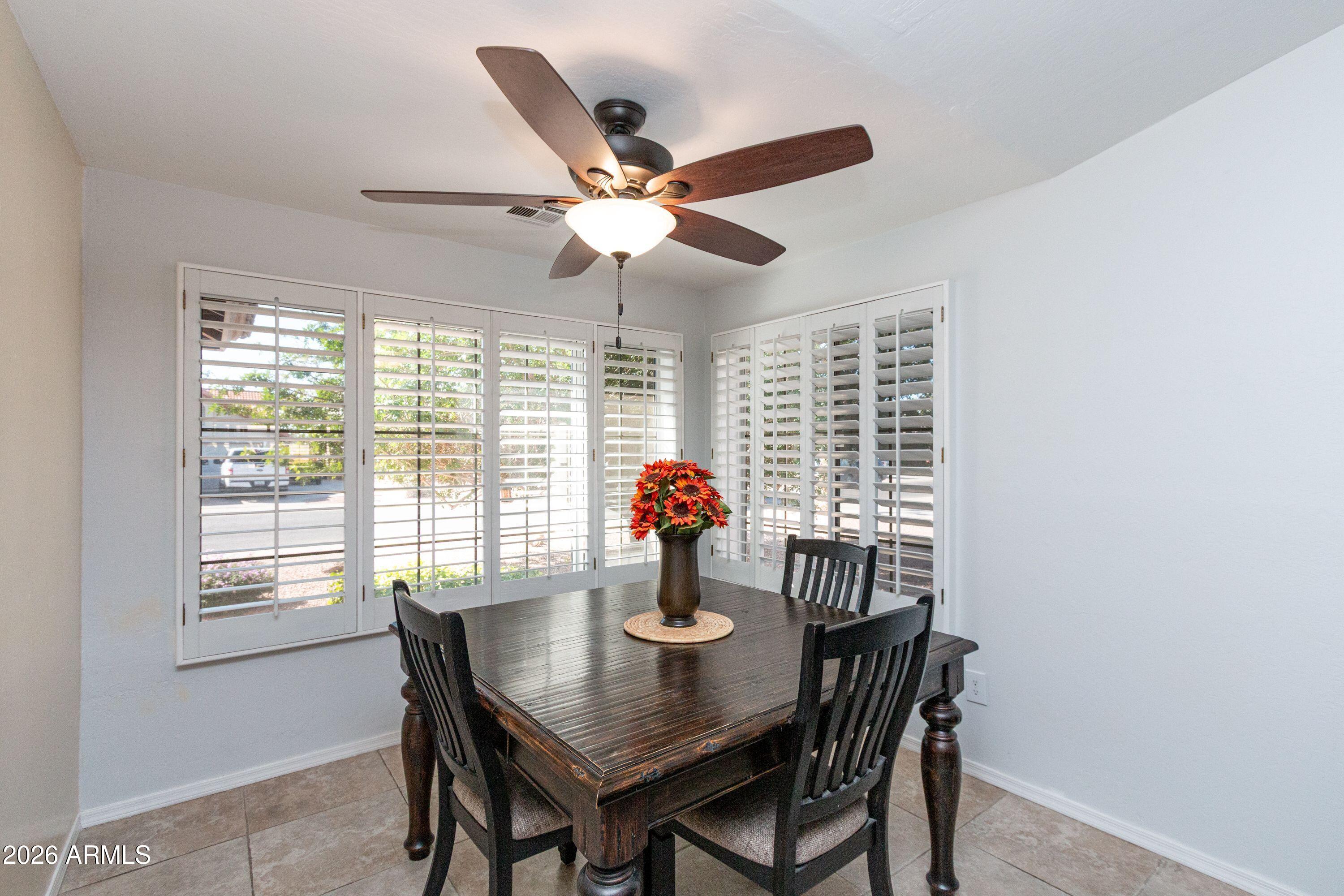 450 East Merrill Avenue Gilbert, AZ 85234 - Photo 8 of 26 a dining room with furniture a chandelier and a large window
