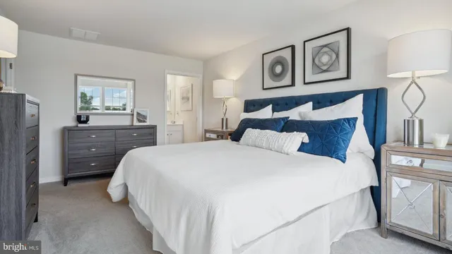 a bedroom with a bed and painting on the wall